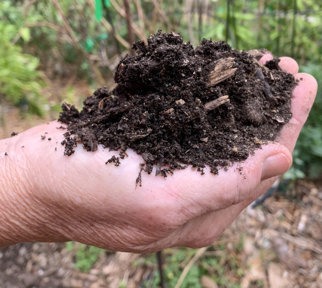 This photo is of a handful of soil.  Soil is  composed of minerals (which break down into 92 elements) and decomposing organic matter.  