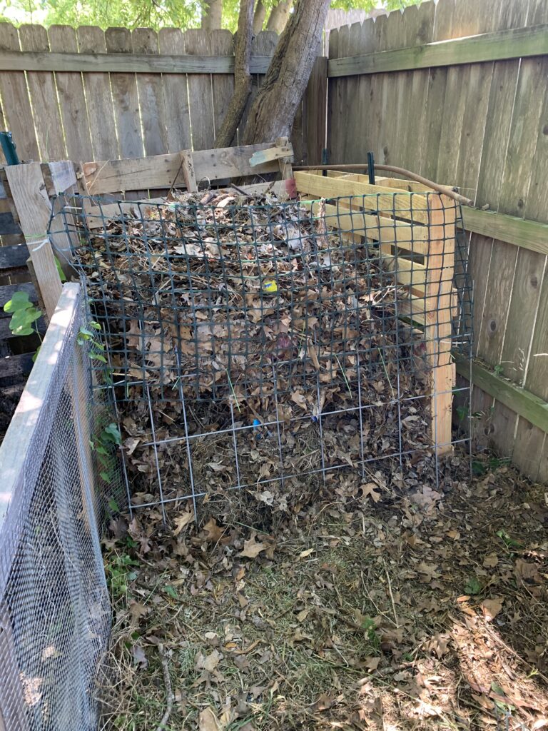 This  photo shows another door method.  It has plastic gardening webbing on the top and a part of a stock panel on the bottom.  Later, I combined the two so that the compost wouldn't spill out the bottom.